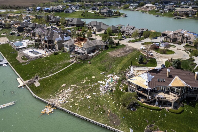 Damaged homes are seen after a tornado hit the Newport Landing neighborhood in Bennington, Neb., Saturday, April 27, 2024. Dozens of reported tornadoes wreaked havoc Friday in the Midwest. (Chris Machian/Omaha World-Herald via AP)