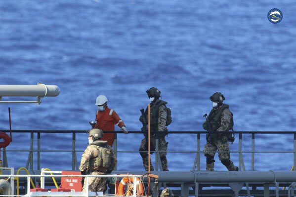 A boarding team inspects the Merchant Vessel Royal Diamond 7, in international waters, 150 kilometers north of the Libyan city of Derna, Thursday, Sept. 10, 2020. The European Union maritime force enforcing the U.N. arms embargo on Libya said Thursday it re-directed a tanker headed for Libya after determining it contained jet fuel in possible violation of the embargo. The MV Royal Diamond 7 was en route early Thursday from Sharjah, United Arab Emirates to Benghazi, Libya when members of the EU force Operation Irini boarded the ship. (EUNAVFOR Med Irini/Italian Defense Ministry via AP)