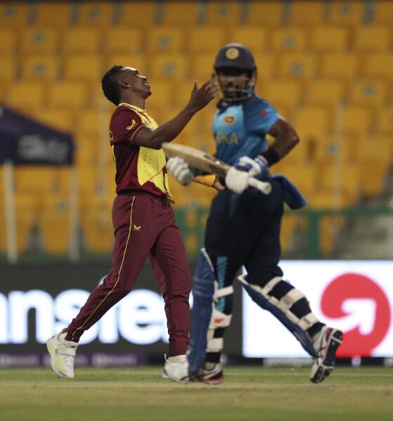 West Indies' Dwayne Bravo reacts after a Sri Lankan batsman scored four runs during the Cricket Twenty20 World Cup match between Sri Lanka and West Indies in Abu Dhabi, UAE, Thursday, Nov. 4, 2021. (AP Photo/Kamran Jebreili)