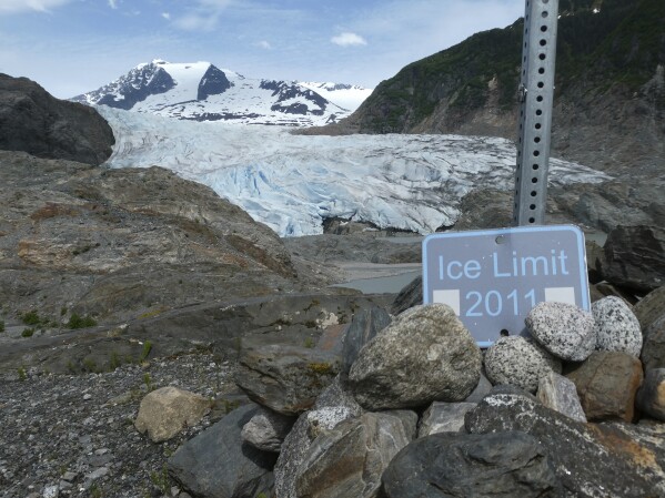 The "Ice Limit 2011" sign shows the Mendenhall Glacier's retreat on June 8, 2023, in Juneau, Alaska. (AP Photo/Becky Bohrer)