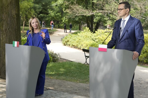 Poland's Prime Minister Mateusz Morawiecki, right, and Italy's Prime Minister Giorgia Meloni speak during a news conference following their talks, that included European Union's plan for sharing responsibility for unauthorised migration, at the palace in Lazienki Park, in Warsaw, Poland, Wednesday, July 5, 2023. (AP Photo/Czarek Sokolowski)