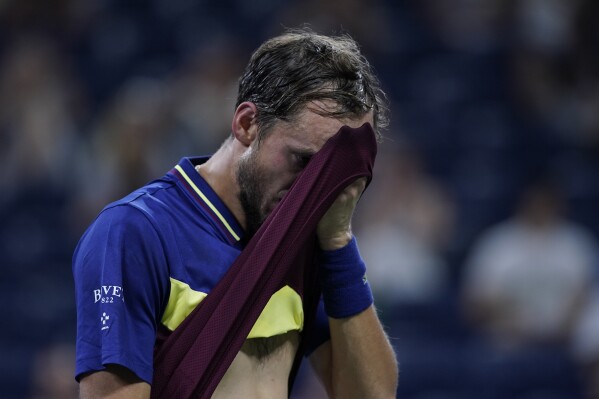 Daniil Medvedev, of Russia, wipes his face during a fourth round match against Alex de Minaur, of Australia, of the U.S. Open tennis championships, Monday, Sept. 4, 2023, in New York. (AP Photo/Eduardo Munoz Alvarez)