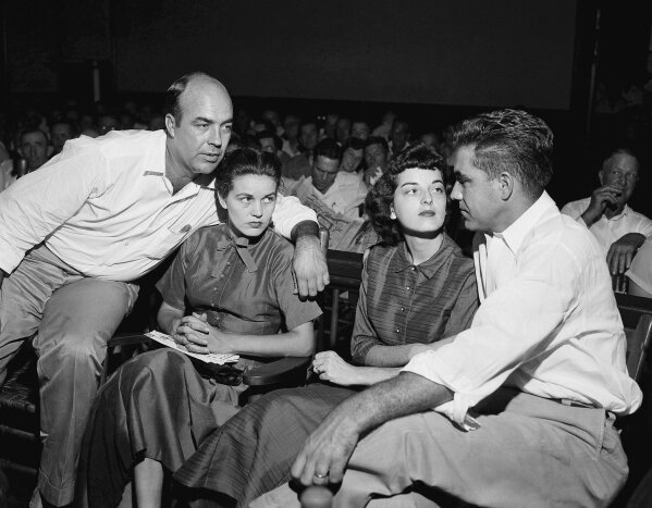 
              FILE - In this Sept. 23, 1955, file photo, J.W. Milam, left, his wife, second left, Roy Bryant, far right, and his wife, Carolyn Bryant, sit together in a courtroom in Sumner, Miss. Bryant and his half-brother Milam were charged with murder but acquitted in the kidnap-torture slaying of 14-year-old black teen Emmett Till in 1955 after he allegedly whistled at Carolyn Bryant. The men later confessed in a magazine interview but weren’t retried; both are now dead. Citing "new information," the U.S. Justice Department has reopened the investigation into Till's death. (AP Photo, File)
            