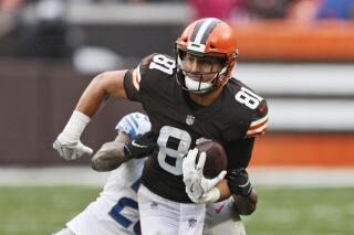 FILE - Cleveland Browns tight end Austin Hooper (81) tries to break a tackle by Detroit Lions safety Will Harris (25) during the first half of an NFL football game, Sunday, Nov. 21, 2021, in Cleveland. Cleveland plans to release tight end Austin Hooper, said a person who spoke on condition of anonymity because teams can’t make free agency signings or other moves until the new NFL league year begins at 4 p.m.(AP Photo/Ron Schwane, File)