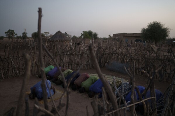 Members of the community pray during the holy month of Ramadan in front of their mosque in the village of Anndiare, in the Matam region of Senegal, Wednesday, April 12, 2023. (AP Photo/Leo Correa)