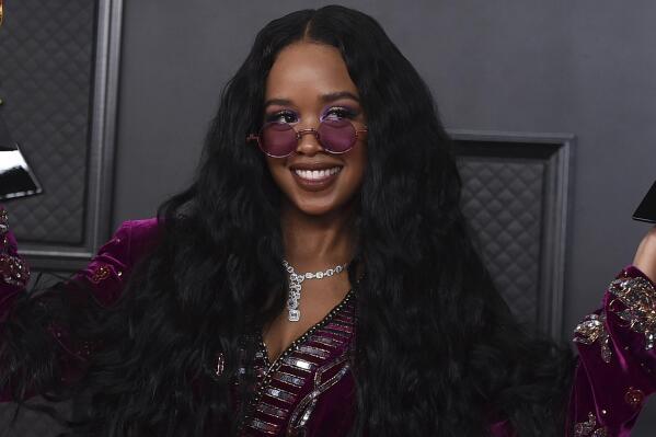 FILE - H.E.R. appears at the 63rd annual Grammy Awards in Los Angeles on March 14, 2021. The four-time Grammy winner will embark on her 19-city Back of My Mind tour in early April while separately joining Coldplay for their world tour as a supporting act later this month. (Photo by Jordan Strauss/Invision/AP, File)