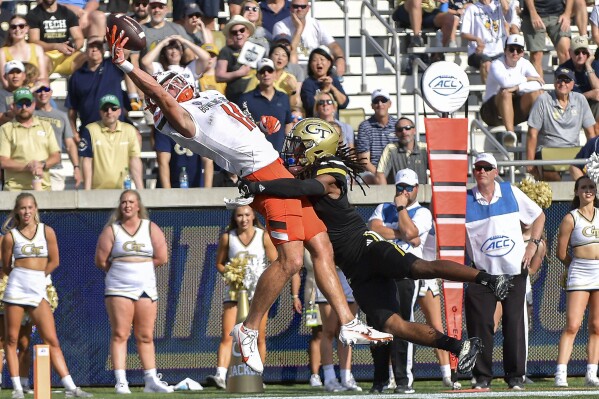 Bowling Green wide receiver Finn Hogan (11) hauls in a pass under pressure from Georgia Tech defensive back LaMiles Brooks (1) during the first half of an NCAA college football game Saturday, Sept. 30, 2023, in Atlanta. /Atlanta Journal-Constitution via AP)