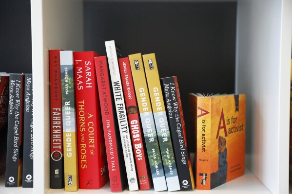 FILE - Books are displayed at the Banned Book Library at American Stage, Feb. 18, 2023, in St. Petersburg, Fla. A lawsuit can move forward against the Escambia County School District, a Florida Panhandle school district, over its removal of books about race and LGBTQ+ identities from library shelves, a federal judge ruled Wednesday, Jan. 10, 2024. (Jefferee Woo/Tampa Bay Times via AP, File)