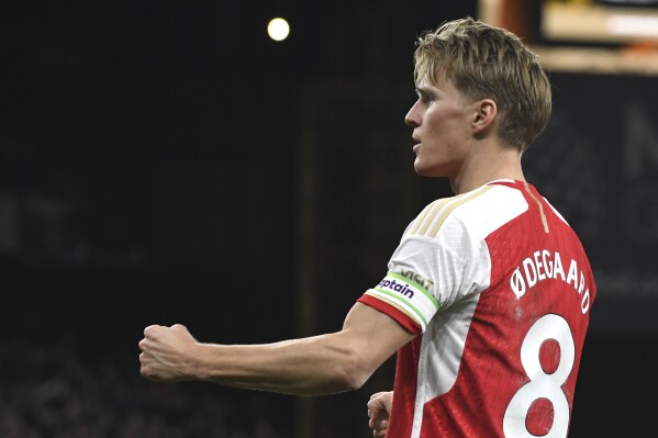 Arsenal's Martin Odegaard celebrates after scoring his side's second goal during the English Premier League soccer match between Wolverhampton Wanderers and Arsenal at the Molineux Stadium in Wolverhampton, England, Saturday, April 20, 2024. (AP Photo/Rui Vieira)