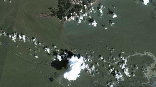 In a satellite image provided by Maxar Technologies, an oil slick is shown on Sept. 2, 2021 south of Port Fourchon, La.  The U.S. Coast Guard said Saturday, Sept. 4,  that cleanup crews are responding to a sizable oil spill in the Gulf of Mexico following Hurricane Ida.  (Maxar Technologies via AP)
