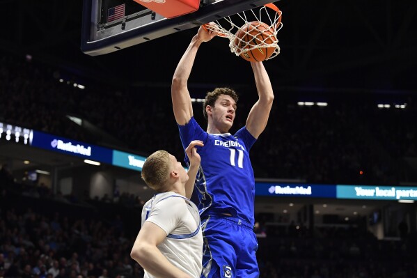 Creighton center Ryan Kalkbrenner (11) dunks the ball over Xavier forward Sasa Ciani (21) during the second half of an NCAA college basketball game in Cincinnati, Ohio, Saturday, Feb. 10, 2024. Creighton won 78-71. (AP Photo/Timothy D. Easley)