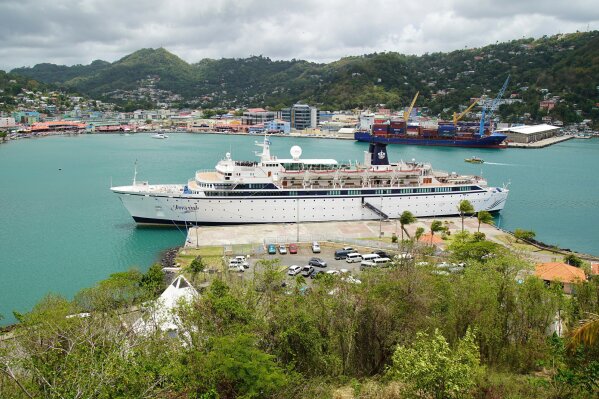 
              The Freewinds cruise ship is docked in the port of Castries, the capital of St. Lucia, Thursday, May 2, 2019. Authorities in the eastern Caribbean island have quarantined the ship after discovering a confirmed case of measles aboard. (AP Photo/Bradley Lacan)
            