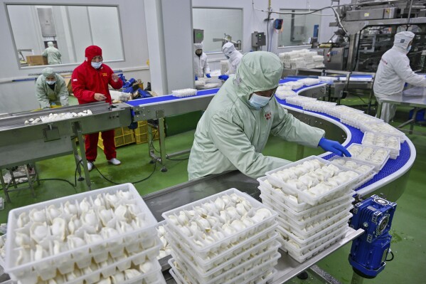 Workers pack dumplings at a production line at a food factory in Suqian city in east China's Jiangsu province on Jan. 21, 2025. (Chinatopix Via AP, File)
