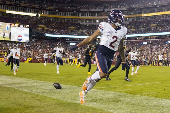 Chicago Bears wide receiver DJ Moore (2) smiles after stepping out of bounds during the first half of an NFL football game against the Washington Commanders, Thursday, Oct. 5, 2023, in Landover, Md. (AP Photo/Alex Brandon)