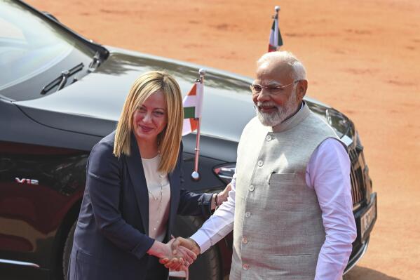 Italian Premier Giorgia Meloni, left, is received by Indian Prime Minister Narendra Modi, as she arrives for a ceremonial reception at the Indian Presidential Palace in New Delhi, India, Thursday, March 2, 2023. (AP Photo)