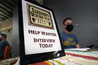 FILE - A hiring sign is placed at a booth for Jameson's Irish Pub during a job fair Wednesday, Sept. 22, 2021, in the West Hollywood section of Los Angeles.  In a surprising burst of hiring, America’s employers added 467,000 jobs in January 2022 in a sign of the economy’s resilience even in the face of a wave of omicron infections last month. (AP Photo/Marcio Jose Sanchez, File)