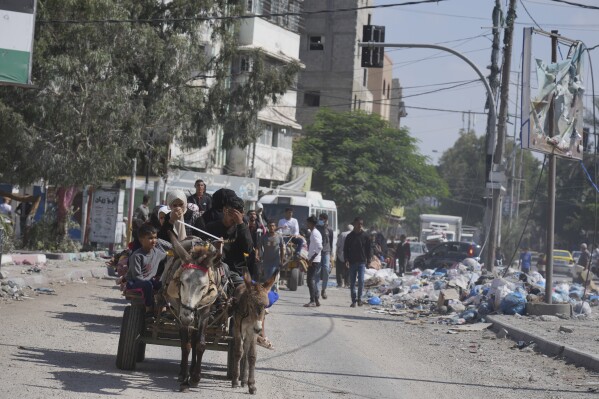 Palestinians flee to the southern Gaza Strip after the Israeli army issued an evacuation warning to a population of over 1 million in northern Gaza and Gaza City to seek refuge in the south ahead of a possible Israeli ground invasion, Friday, Oct. 13, 2023. (AP Photo/Hatem Moussa)