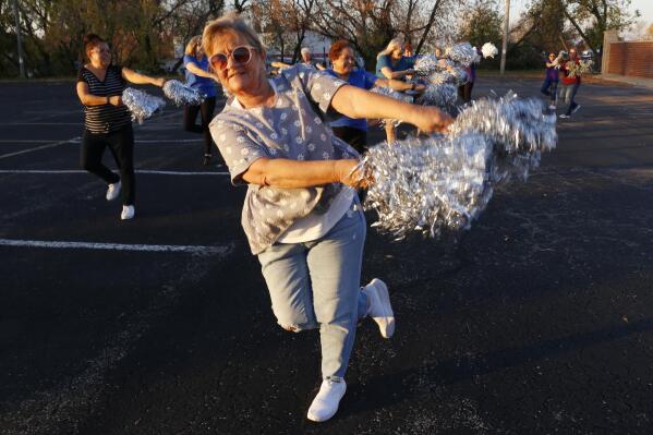 Pam Junion, 65, and other members of the Milwaukee Dancing Grannies practice in a parking lot in Milwaukee on Wednesday, Nov. 2, 2022. Junion is one of a few women who answered a call for new members as the group attempted to rebuild in the face of tragedy. Three Dancing Grannies and one group member’s husband were among those killed at a Christmas parade in Waukesha, Wisconsin, when the driver of an SUV struck them on the parade route. Dozens more, including some Grannies, were injured. (AP Photo/Martha Irvine)