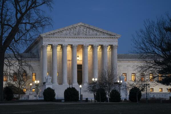 FILE - In this Jan. 22, 2020, file photo, night falls on the Supreme Court in Washington. The Supreme Court is considering whether to hear the case of a Black man who says he suffered discrimination because the N-word was carved into the wall of the hospital elevator where he worked. (AP Photo/J. Scott Applewhite, File)