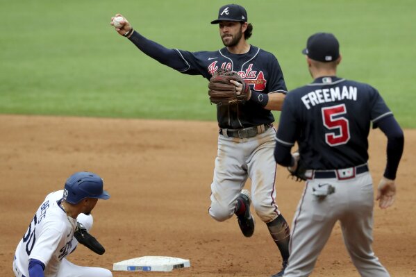 Atlanta Braves shortstop Dansby Swanson, center, is unable to make the throw as Los Angeles Dodgers right fielder Mookie Betts, left, breaks up the double play as Atlanta Braves first baseman Freddie Freeman (5) is shown during the fourth inning in Game 6 Saturday, Oct. 17, 2020, for the best-of-seven National League Championship Series at Globe Life Field in Arlington, Texas. (Curtis Compton/Atlanta Journal-Constitution via AP)
