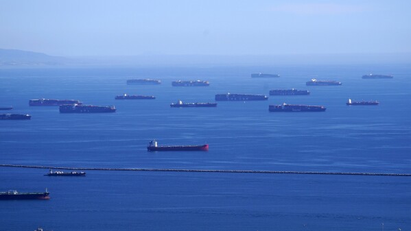 FILE - Cargo ships are seen lined up outside the Port of Los Angeles, Feb. 23, 2021, in Los Angeles. Scientists say by far the biggest cause of the recent extreme warming is human-caused climate change and a natural El Nino. But some say there’s got to be something more. (AP Photo/Mark J. Terrill, File)