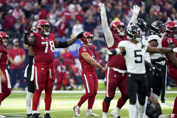 Houston Texans place kicker Matt Ammendola (16), Laremy Tunsil (78), Jacksonville Jaguars' Andre Cisco (5) and others react to Ammendola's unsuccessful long field goal attempt late in the second half of an NFL football game in Houston, Sunday, Nov. 26, 2023. (AP Photo/Eric Gay)