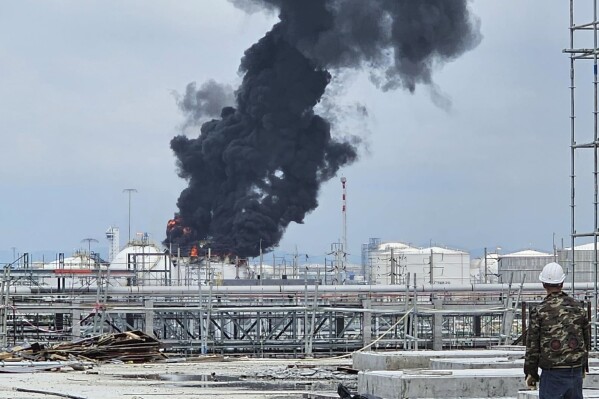 Black smoke billows after an explosion at the gas storage tanks in an industrial area in Rayong province, eastern of Thailand, Thursday, May 9, 2024. At least one person was killed and several others injured after a huge fire broke out at gas storage tanks. (Fire & Rescue Thailand via AP)