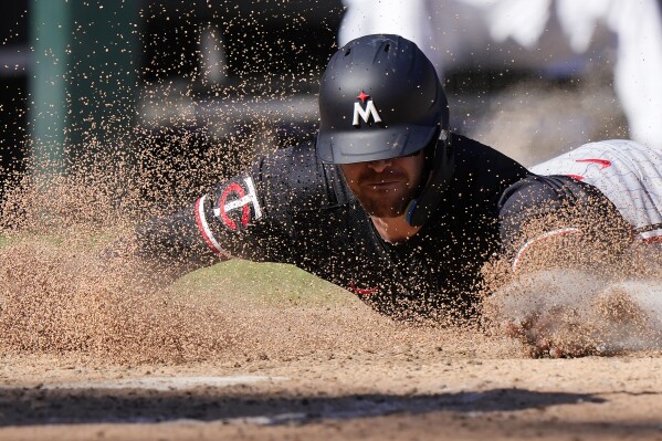 Minnesota Twins' Ryan Jeffers scores on a one-run single by Willi Castro during the ninth inning of a baseball game against the Chicago White Sox in Chicago, Wednesday, May 1, 2024. (AP Photo/Nam Y. Huh)