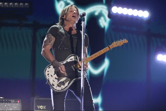 FILE - Keith Urban performs "Texas Time" at the 58th annual Academy of Country Music Awards on May 11, 2023, at the Ford Center in Frisco, Texas. Country superstar Urban and Kix Brooks of powerhouse country duo Brooks & Dunn will be inducted into the Nashville Songwriters Hall of Fame this year, according to an announcement by the organization Thursday, Aug. 3, 2023. (AP Photo/Chris Pizzello, File)