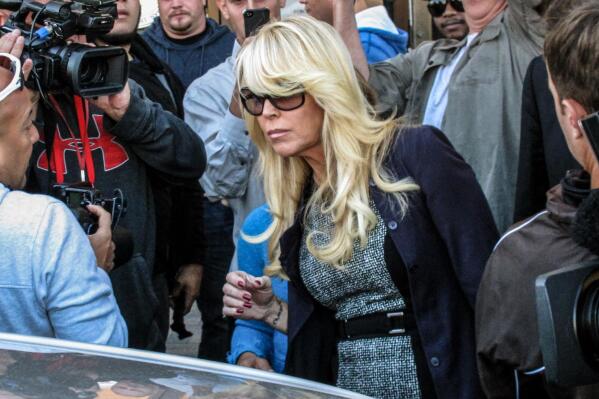 FILE - In this Sept. 24, 2013 file photo, Dina Lohan leaves court in Hempstead, N.Y., after pleading not guilty to drunken driving charges. Lohan pleaded guilty to drunken driving on Tuesday, Sept. 28, 2021, and is expected to be sentenced to 18 days in jail and five years’ probation for rear-ending another car on Long Island and leaving the scene. (AP Photo/Frank Eltman, File)