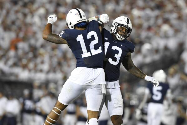 Penn State linebackers Brandon Smith (12) and Ellis Brooks (13) celebrate a stop against Auburn during an NCAA college football game in State College, Pa., on Saturday, Sept. 18, 2021. (AP Photo/Barry Reeger)