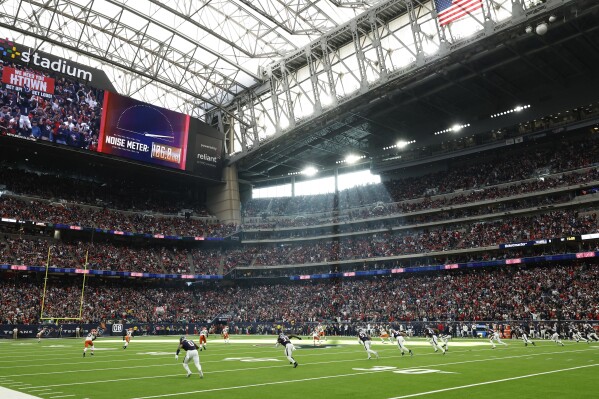 FILE - The opening kickoff in a general stadium view during an NFL wild-card playoff football game, Jan. 13, 2024, in Houston. The NFL competition committee is proposing a rule to penalize so-called “hip-drop” tackles and a radical change to kickoffs to add more returns without compromising safety. (AP Photo/Matt Patterson, File)