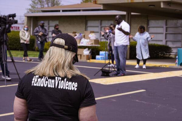 A women wears a shirt calling for the end of gun violence during a vigil at the Olivet Missionary Baptist Church for the victims of the shooting at a FedEx facility in Indianapolis, Saturday, April 17, 2021. A gunman killed eight people and wounded several others before taking his own life in a late-night attack at a FedEx facility near the Indianapolis airport, police said. (AP Photo/Michael Conroy)