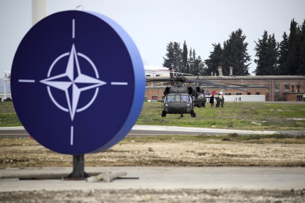 Military helicopters are parked at an airbase in Kocuve, about 85 kilometers (52 miles) south of Tirana, Albania, Monday, March 4, 2024. NATO member Albania inaugurated an international tactic air base on Monday, the Alliance’s first one in the Western Balkan region. (AP Photo/Armando Babani)