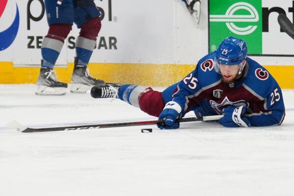 Colorado Avalanche right wing Logan O'Connor (25) tries to control the puck from the ice during the second period in Game 5 of the team's NHL hockey Stanley Cup Final against the Tampa Bay Lightning, Friday, June 24, 2022, in Denver. (AP Photo/Jack Dempsey)