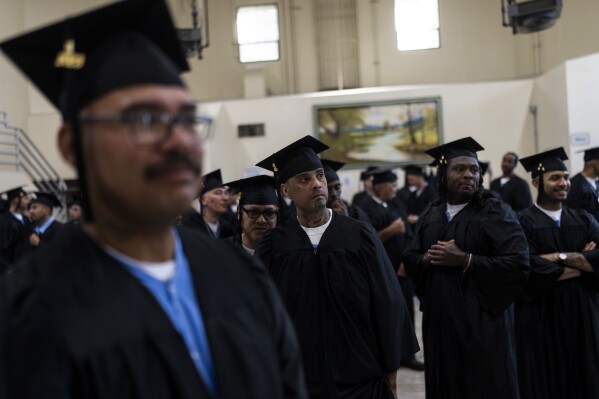 Incarcerated graduates, who finished various educational and vocational programs in prison, wait for the start of their graduation ceremony at Folsom State Prison in Folsom, Calif., Thursday, May 25, 2023. Thousands of prisoners throughout the United States get their college degrees behind bars, most of them paid for by the federal Pell Grant program, which offers the neediest undergraduates tuition aid that they don’t have to repay. That program is about to expand exponentially next month, giving about 30,000 more students behind bars some $130 million in financial aid per year. (AP Photo/Jae C. Hong)