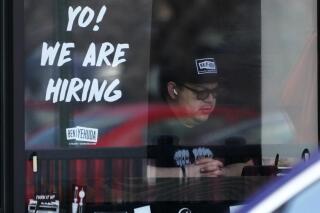 A hiring sign is displayed at a restaurant in Schaumburg, Ill., April 1, 2022. Employers posted a record 11.5 million job openings in March, more evidence of a tight labor market that has emboldened millions of American workers to leave their jobs and contributed to the biggest surge in inflation in four decades. A record 4.5 million Americans quit their jobs in February — a sign that they are confident they can find better pay or working conditions elsewhere. (AP Photo/Nam Y. Huh)