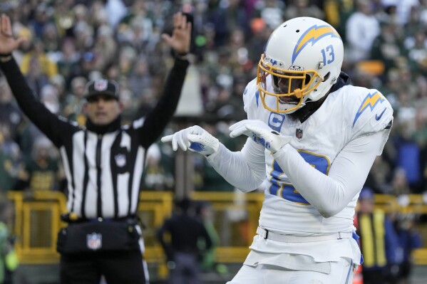 Los Angeles Chargers wide receiver Keenan Allen reacts after catching a touchdown pass from quarterback Justin Herbert during the second half of an NFL football game against the Green Bay Packers, Sunday, Nov. 19, 2023, in Green Bay, Wis. (AP Photo/Morry Gash)