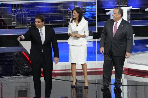 Republican presidential candidates Florida Gov. Ron DeSantis, former U.N. Ambassador Nikki Haley and former New Jersey Gov. Chris Christie walk on stage after a Republican presidential primary debate hosted by NBC News, Wednesday, Nov. 8, 2023, at the Adrienne Arsht Center for the Performing Arts of Miami-Dade County in Miami. (AP Photo/Rebecca Blackwell)