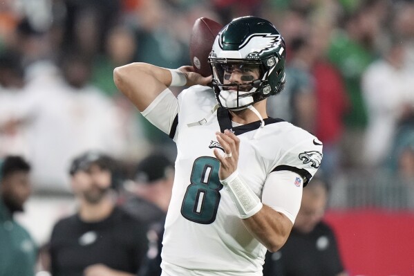 FILE - Philadelphia Eagles quarterback Marcus Mariota (8) warms up near the sidelines during an NFL wild-card playoff football game Monday, Jan. 15, 2024 in Tampa, Fla. The Washington Commanders have added a veteran quarterback in free agency. The team agreed Tuesday, March 12, 2024, with Marcus Mariota on a one-year contract with a base salary of $6 million worth up to $10 million, a person familiar with the deal tells The Associated Press. (AP Photo/Peter Joneleit, File)