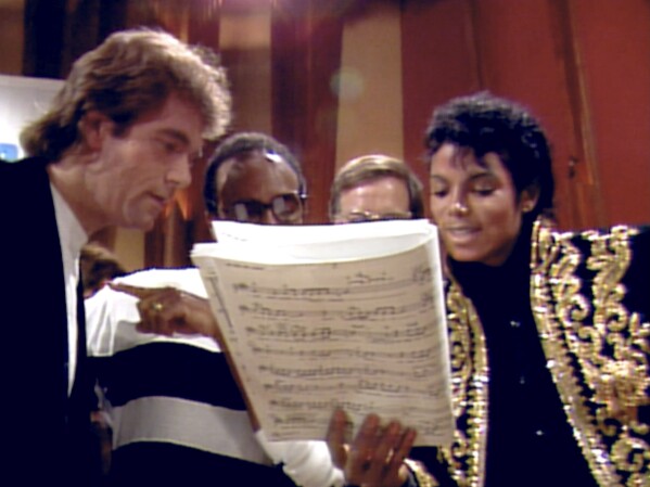 This image released by Netflix shows, from left, Huey Lewis, Quincy Jones and Michael Jackson, right, in a scene from "The Greatest Night in Pop." (Netflix via AP)