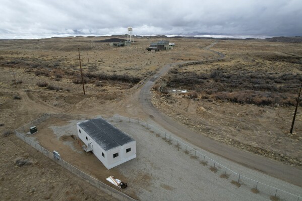 A trailer, bottom left, sits Thursday, Jan. 25, 2024, on land owned by Anson Resources in Green River, Utah. The Australian company with its U.S. subsidiaries is eyeing a nearby area to extract lithium. Top center is an abandoned uranium mine. (AP Photo/Brittany Peterson)