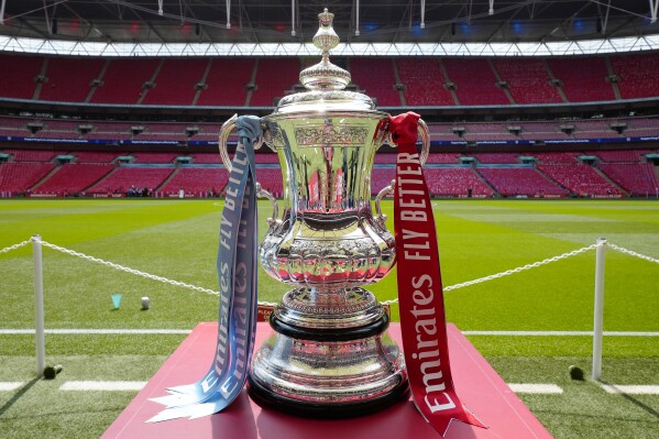 FILE - The FA Cup trophy is seen before the English FA Cup final soccer match between Manchester City and Manchester United at Wembley Stadium in London, Saturday, June 3, 2023. FA Cup replays have for so long been a big money-maker for lower-division teams in English soccer but they are being scrapped from next season. Organizers are citing “expanded UEFA competitions” as a reason for the move. (AP Photo/Jon Super, File)