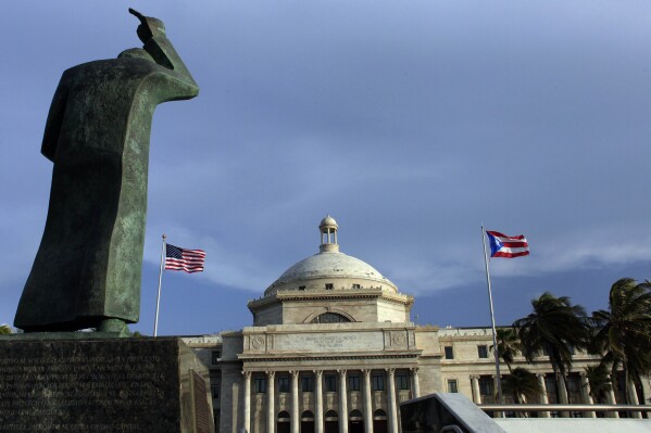 FILE - The Capitol of Puerto Rico stands in San Juan, Puerto Rico, July 29, 2015. President Joe Biden won the Democratic presidential primary Sunday, April 28, 2024, in the U.S. territory of Puerto Rico. Puerto Rico was authorized to open only a dozen voting centers this year compared with more than 100 in previous years given recent austerity measures imposed by a federal control board that oversees the island’s finances. (AP Photo/Ricardo Arduengo, File)