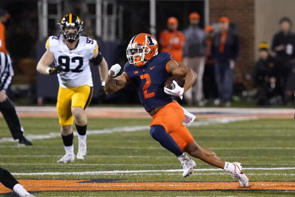 Illinois running back Chase Brown carries the ball during the first half of an NCAA college football game against the Iowa Saturday, Oct. 8, 2022, in Champaign, Ill. (AP Photo/Charles Rex Arbogast)