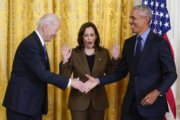 Vice President Kamala Harris reacts as President Joe Biden shakes hands with former President Barack Obama after Obama jokingly called Biden vice president in the East Room of the White House in Washington, Tuesday, April 5, 2022. (AP Photo/Carolyn Kaster)