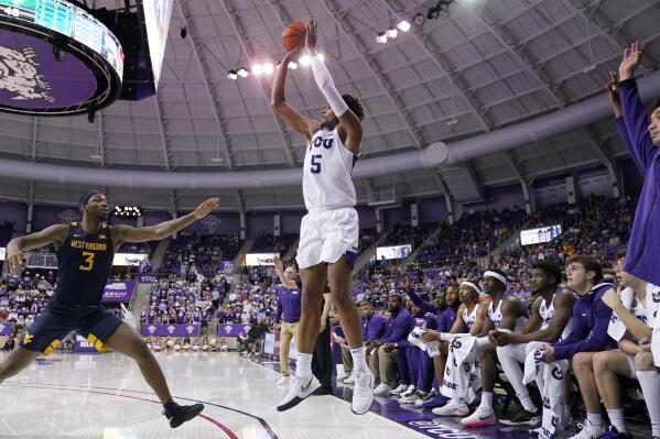 West Virginia forward Gabe Osabuohien (3) defends against a 3-point shot-attempt by TCU forward Chuck O'Bannon Jr. (5) in the second half of an NCAA college basketball game in Fort Worth, Texas, Monday, Feb. 21, 2022. (AP Photo/Tony Gutierrez)