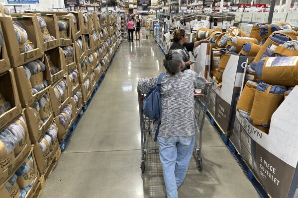 Shoppers look at blankets on sale in a Costco warehouse Thursday, Aug. 24, 2023, in Sheridan, Colo. On Wednesday, the Labor Department issues its consumer prices report for August. (AP Photo/David Zalubowski)