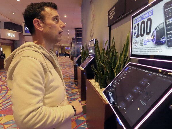 Matt Smircich, of Hamburg, N.J., makes sports bets at the Hard Rock casino in Atlantic City, N.J., Friday, Feb. 2, 2024. On Tuesday, Feb. 6, 2024, the American Gaming Association estimated that a record 68 million Americans would wager a total of $23.1 billion on this year's Super Bowl, legally or otherwise. (AP Photo/Wayne Parry)