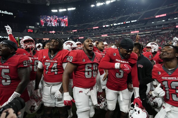 UNLV players celebrate after defeating Vanderbilt in an NCAA college football game Saturday, Sept. 16, 2023, in Las Vegas. (AP Photo/John Locher)